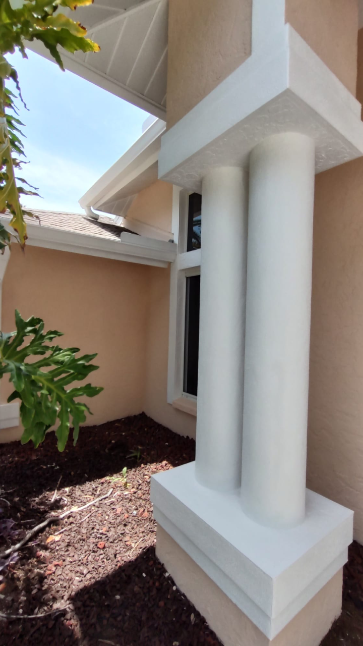 Close-up of clean white columns and exterior wall after a pressure washing service