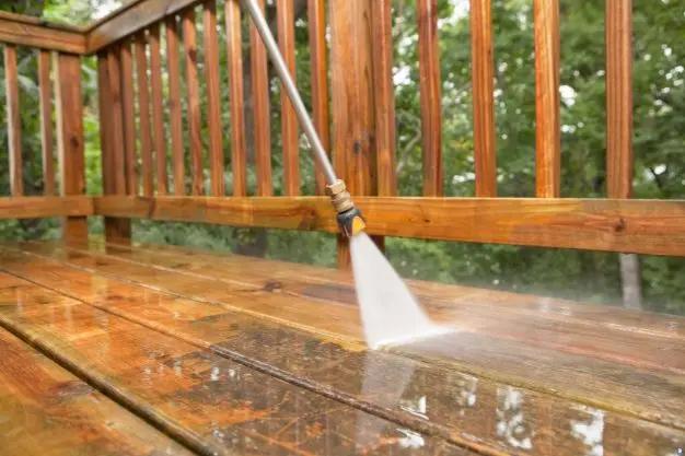 Pressure washing a wooden deck