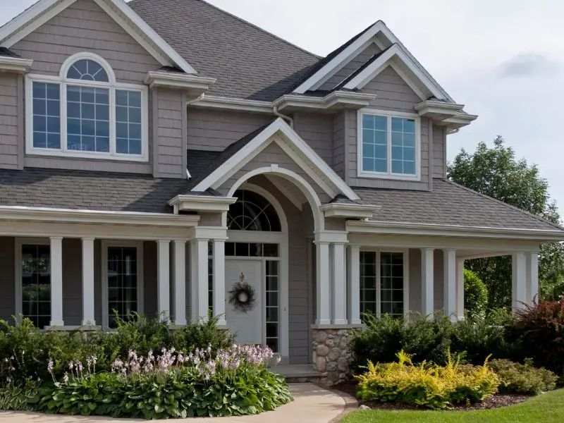 Exterior home painting with smooth siding finish and bright white trim in Bradenton, FL